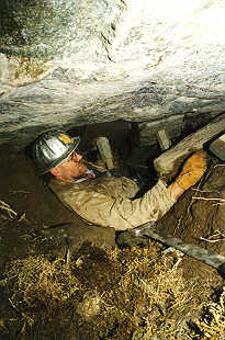 Carroll Vogel in cave beneath anchor rock, securing 10' long through-bolts.