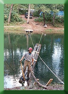 Peter Henrikson floating tower poles and anchor rods across Kimberling Creek