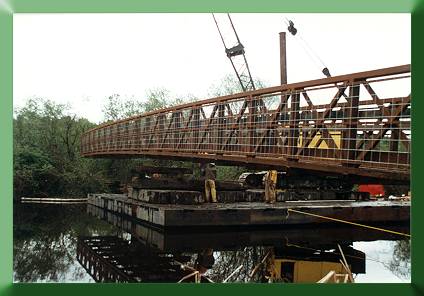 Assembling two halves of Continental Bridge with crane (on barge).