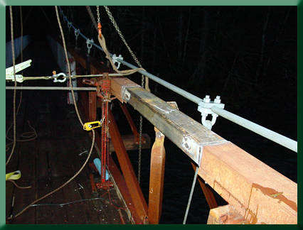 Replacement chord section with jack and straps holding chord in alignment for welding.