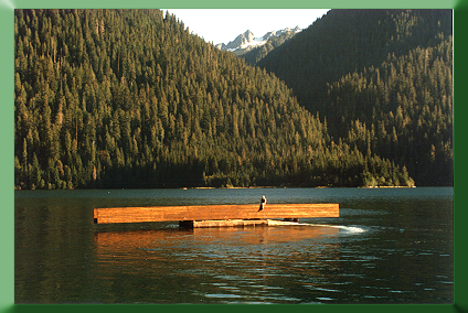 Floating glu-laminated stringers across Baker Lake for 77' long Noisy Creek Bridge., WA, 1995