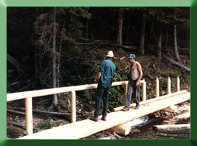 Randy Hessong and Carroll Vogel on Trout Lake Bridge, YNP, WY, 1989.